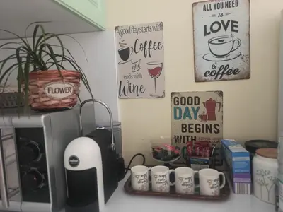 a kitchen counter with cups and signs on the wall at Apartment Maddie in Teteven