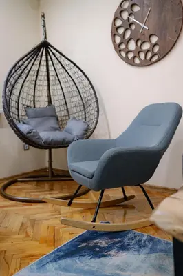 a swing chair in a living room with a clock at Top Center Retreat, Close to Main street, FREE Parking in Sofia