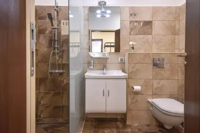 a bathroom with a toilet and a sink and a shower at Top Center Retreat, Close to Main street, FREE Parking in Sofia