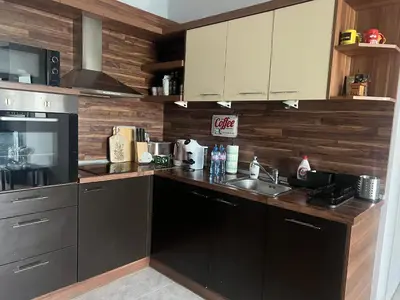 a kitchen with stainless steel appliances and wooden walls at Brand NEW! 2BDR Lux Apartment RAYKO in Sofia