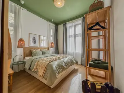 a bedroom with a bed and a wooden ladder at Bohemian Hideaway Historic Center Sofia Parking in Sofia