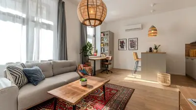 a living room with a couch and a table at Bohemian Hideaway Historic Center Sofia Parking in Sofia