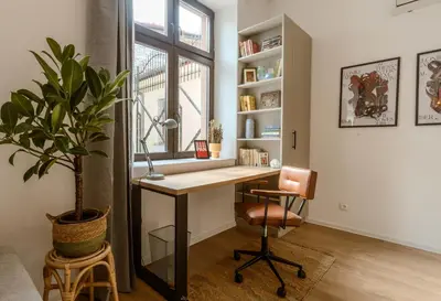 a home office with a desk and a potted plant at Bohemian Hideaway Historic Center Sofia Parking in Sofia