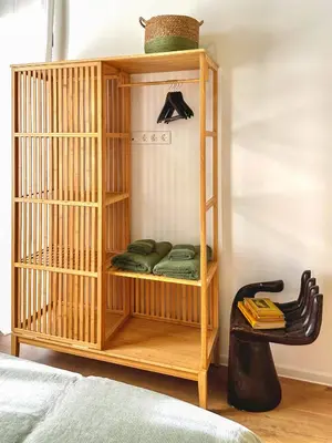 a wooden book shelf with green pillows in a room at Bohemian Hideaway Historic Center Sofia Parking in Sofia