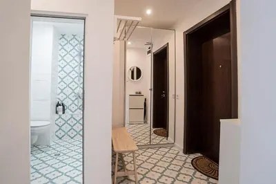 a bathroom with a toilet and a glass doorway at Cozy Apartment Overlooking The Park in Sofia