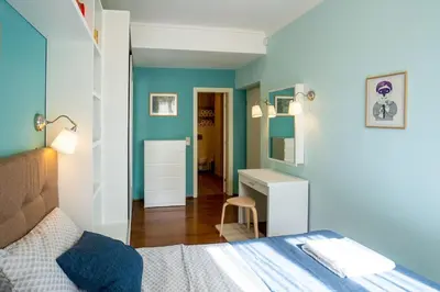 a bedroom with a bed and a desk with a chair at Home in Sofia's Beating Heart in Sofia