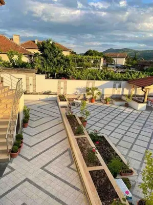 a patio with some plants and flowers on it at Boris House 5 bed Villa & Private Pool in Strumyani