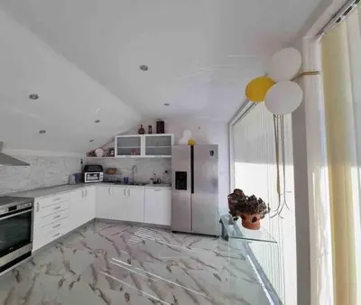 a kitchen with a refrigerator and a table with a vase at Boris House 5 bed Villa & Private Pool in Strumyani