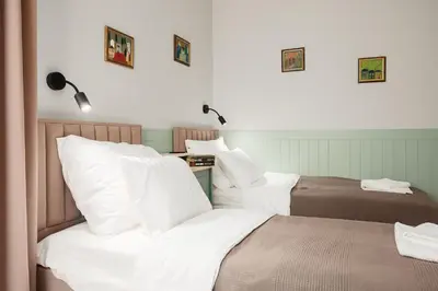 two beds in a room with white sheets at Brand New 2 bdr Luxury Apartment in Top Centre in Sofia