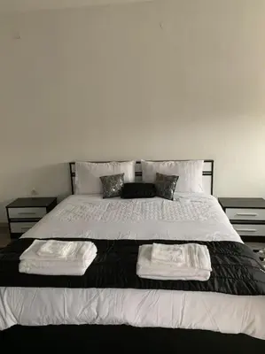a bedroom with a large bed with two towels on it at Luxury Apartment Eleni in centre of Sandanski in Sandanski