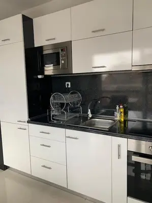 a white kitchen with a sink and a microwave at Luxury Apartment Eleni in centre of Sandanski in Sandanski