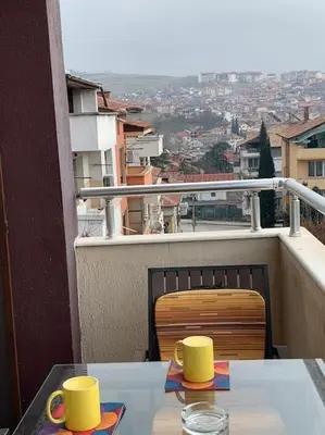 a table with two yellow cups on a balcony at Luxury Apartment Eleni in centre of Sandanski in Sandanski
