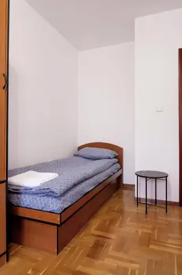 a bedroom with a bed and a table at Домът на архитекта The Architect's Home in Plovdiv