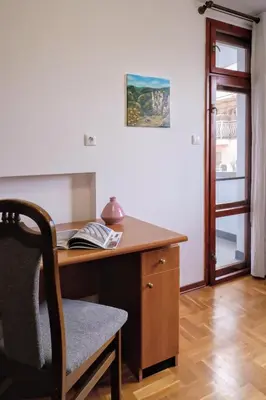 an office with a wooden desk with a chair at Домът на архитекта The Architect's Home in Plovdiv
