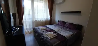 a bedroom with a bed and a tv and a window at JESY apartment,Borovets Gardens in Borovets