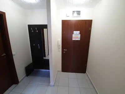 a hallway with two wooden doors in a room at JESY apartment,Borovets Gardens in Borovets