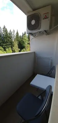 a room with a table and a chair and a fan at JESY apartment,Borovets Gardens in Borovets