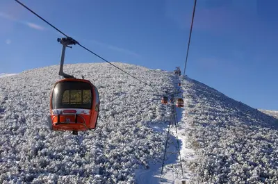a ski lift going up a snow covered mountain at JESY apartment,Borovets Gardens in Borovets