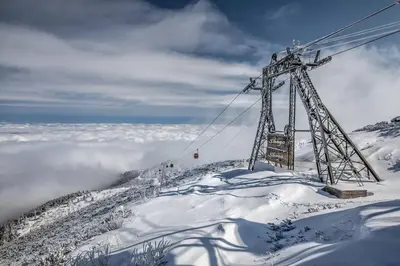 a ski lift on top of a snow covered mountain at JESY apartment,Borovets Gardens in Borovets