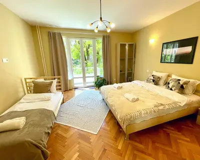 a bedroom with two beds and a window at Bohemian Bright & Calm 2BR - Top center - Private Balcony in Sofia