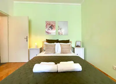 a bedroom with a large bed with two pillows at Bohemian Bright & Calm 2BR - Top center - Private Balcony in Sofia