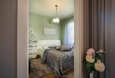 a bedroom with a bed and a dresser and a mirror at Bright Inn - Holiday & Business Apartment in Sofia
