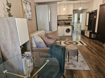 a living room with a couch and a table at Bright Inn - Holiday & Business Apartment in Sofia