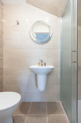 a bathroom with a sink and a shower at Millennia Hotel in Sofia
