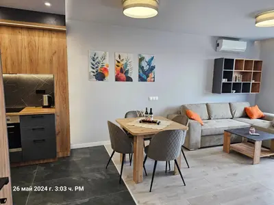 a living room with a table and a couch at Dilyanka 2 in Pernik