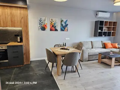 a kitchen and living room with a table and a couch at Dilyanka 2 in Pernik