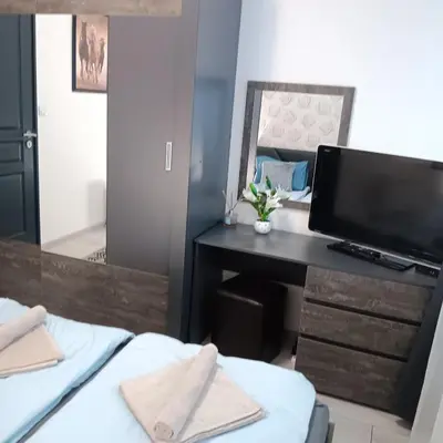 a bedroom with two beds and a desk and a mirror at Doble next to Bulgaria mall, FREE underground parking in Sofia