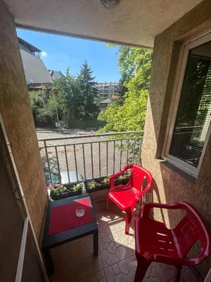 two red chairs and a table on a balcony at Private studio in the city center, close to subway, Medical University in Sofia