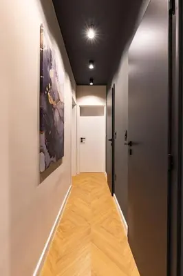 a hallway with a white door and a wooden floor at Sunset 2BR Apartment Central Street PARKING Included in Plovdiv