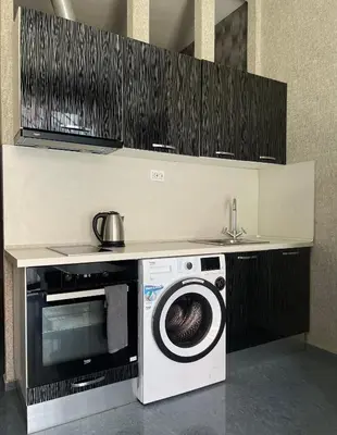 a kitchen with a microwave and a washing machine at Flower house 6 in Sofia