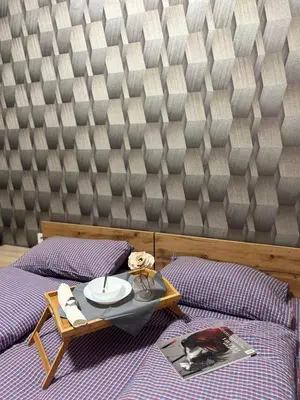 a bedroom with two beds with a table and a magazine at Flower house 6 in Sofia