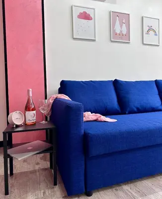 a blue couch in a living room with a side table at The rainbow 9 in Sofia