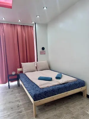 a bedroom with a bed in a room with red curtains at The rainbow 9 in Sofia