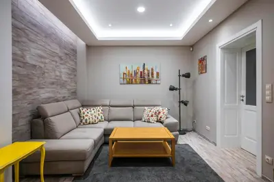 a living room with a couch and a table at Elegant Escape in The Heart of The City by Flat Mаnager in Sofia