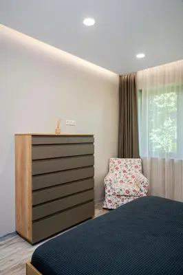 a bedroom with a bed and a dresser at Elegant Escape in The Heart of The City by Flat Mаnager in Sofia