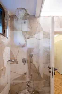 a bathroom with a shower with a glass door at SOFapart Stylish & Fancy Place with 1 BDR in Sofia