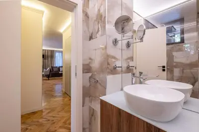 a white bathroom with a sink and a mirror at SOFapart Stylish & Fancy Place with 1 BDR in Sofia
