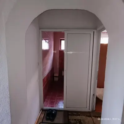 a hallway with a white door in a room at Стаи за гости Божана in Razlog