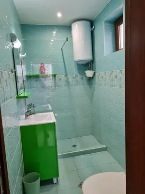 a bathroom with a shower and a sink and a toilet at Cozy studio with balcony in Sofia