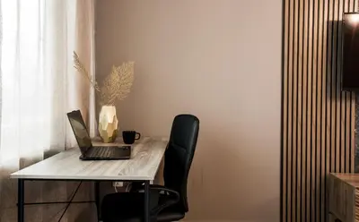 a desk with a laptop computer on top of it at Rome Stylish apt w Working Space and Paid Parking Spot in Sofia