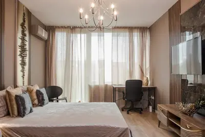 a bedroom with a bed and a table and a window at Rome Stylish apt w Working Space and Paid Parking Spot in Sofia