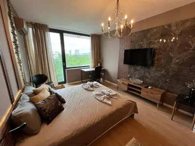 a bedroom with a large bed and a large window at Rome Stylish apt w Working Space and Paid Parking Spot in Sofia