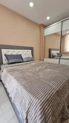 a bedroom with a large bed with a large mirror at Апартаменти Недялкови I in Sandanski