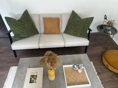 a living room with a couch and a table at Rodopi Mountain Village House in Narechen