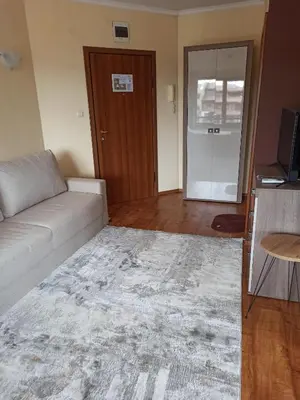 a living room with a couch and a table at Роси Студио Банско in Bansko
