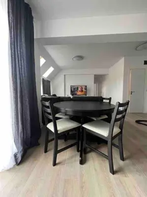 a dining room with a black table and chairs at Sandanski escape in Sandanski
